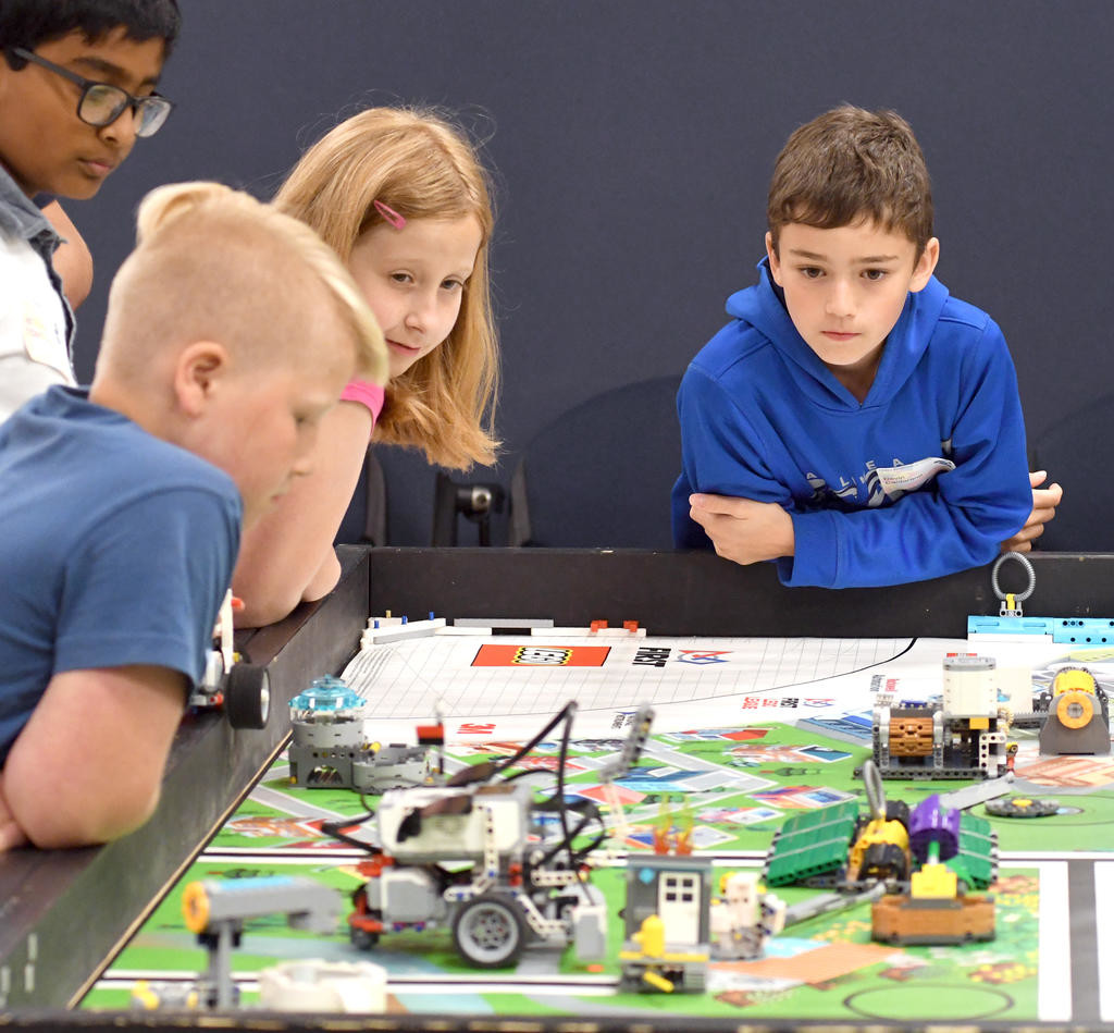 WATCHING ROBOTS AT WORK — Students from various local school districts view a programmed robot in motion on Wednesday during a week-long Lego Robotics camp at the Griffiss Institute. From left: Nitesh Constantine from the New Hartford district; Elliot Meays from the Holland Patent district; Isabella Turner from the Vernon-Verona-Sherrill district; and Devin Cantarano from the Rome district. The camp is part of a STEM (science, technology, engineering, math) Outreach Summer Program by the institute and the Rome Air Force Research Laboratory Information Directorate.
 (Sentinel photo by John Clifford)
