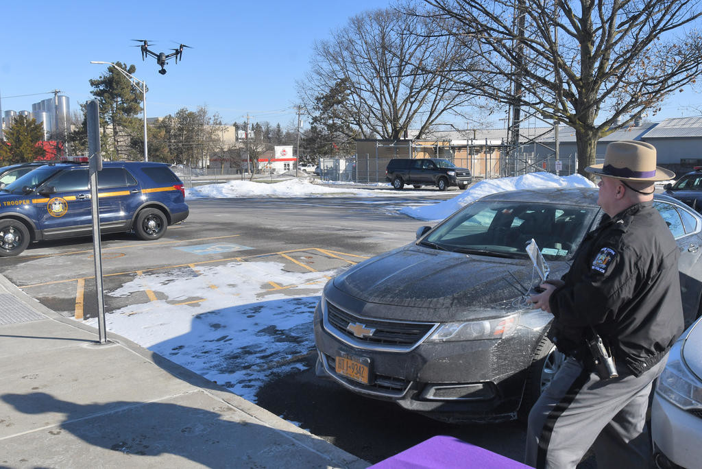 TEST FLIGHT — State Police Sgt. David Olney takes the new drone out for a spin over the Troop D Headquarters parking lot in Oneida on Friday.
 (Sentinel photo by John Clifford)