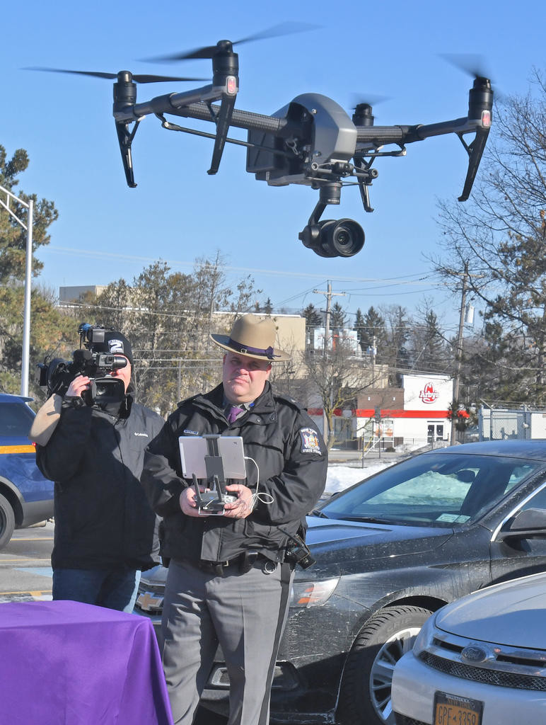 OUT FOR A SPIN — State Police Sgt. David Olney takes the new drone out for a spin over the Troop D Headquarters parking lot in Oneida on Friday.
 (Sentinel photo by John Clifford)