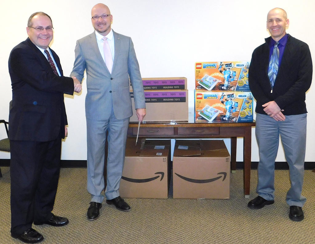 ROBOTICS KITS DONATED — Presenting a donation of 18 LEGO Boost Robotics kits to the Rome school district were, at left, Front of the Class charity President Bill McCormick and at right, Jeff DeMatteis, STEM (science, technology, engineering, math) outreach coordinator for the Air Force Research Laboratory Information Directorate. At center is school district Superintendent Peter C. Blake.
 (Photo submitted)