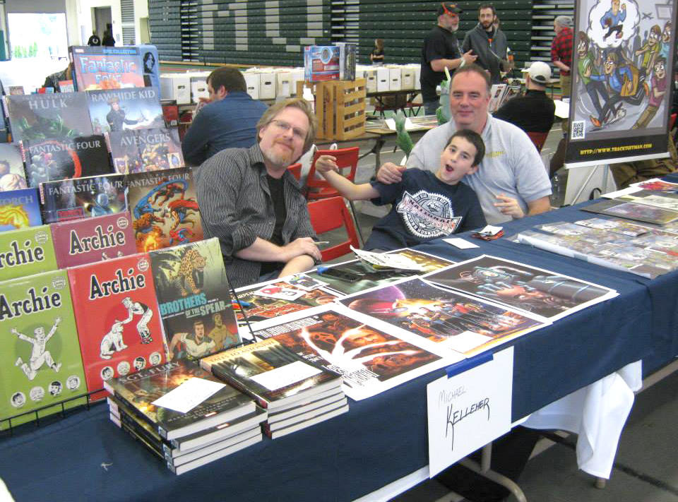 COLORIST — Comic book colorist Michael Kelleher, left, selling his comics and prints at Uticon. He's joined by artist Len Mihalovich and son.
 (Photo submitted)