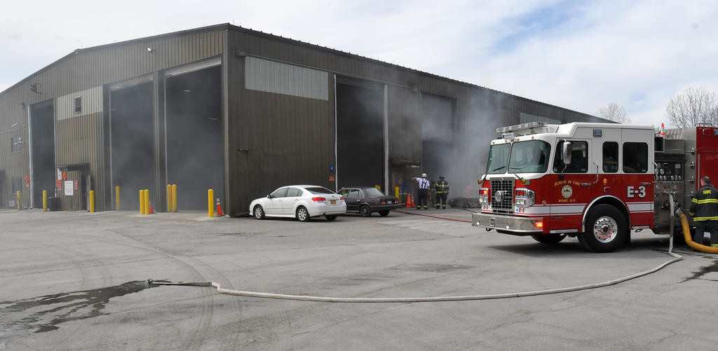 BURNING INSIDE — Smoke puffs out of the Western Transfer Station on Perimeter Road while the garbage burns inside.
 (Sentinel photo by John Clifford)