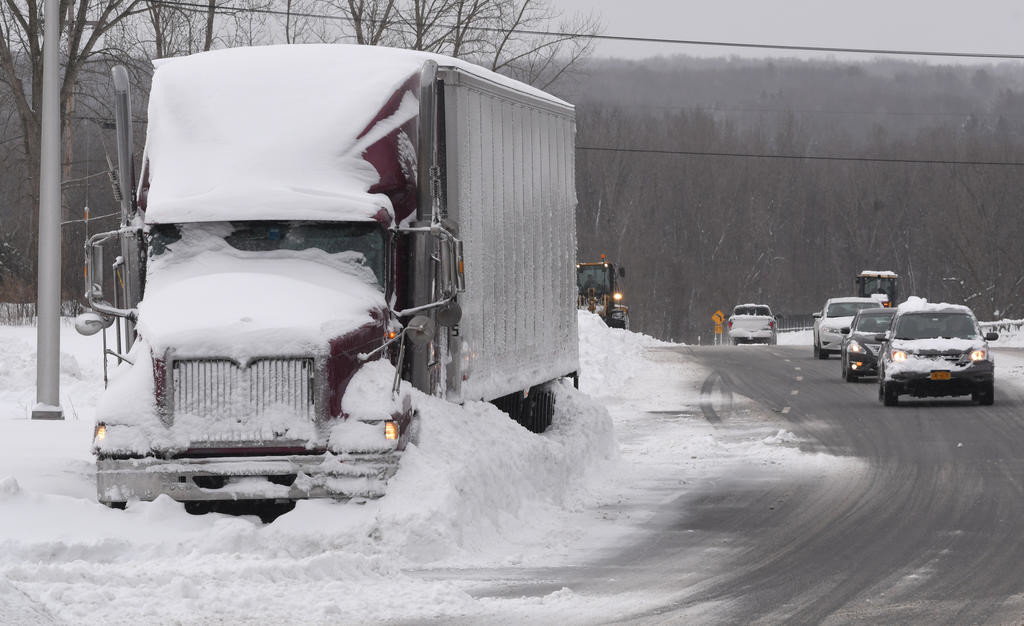 SNOWED IN — A tractor-trailer is plowed in and covered with snow as it sits off of Route 825 — just past the Route 49 exit ramp. Traffic was curtailed across the area as the massive winter storm Stella socked the area, dropping nearly two feet of snow Tuesday.
 (Sentinel photo by John Clifford)