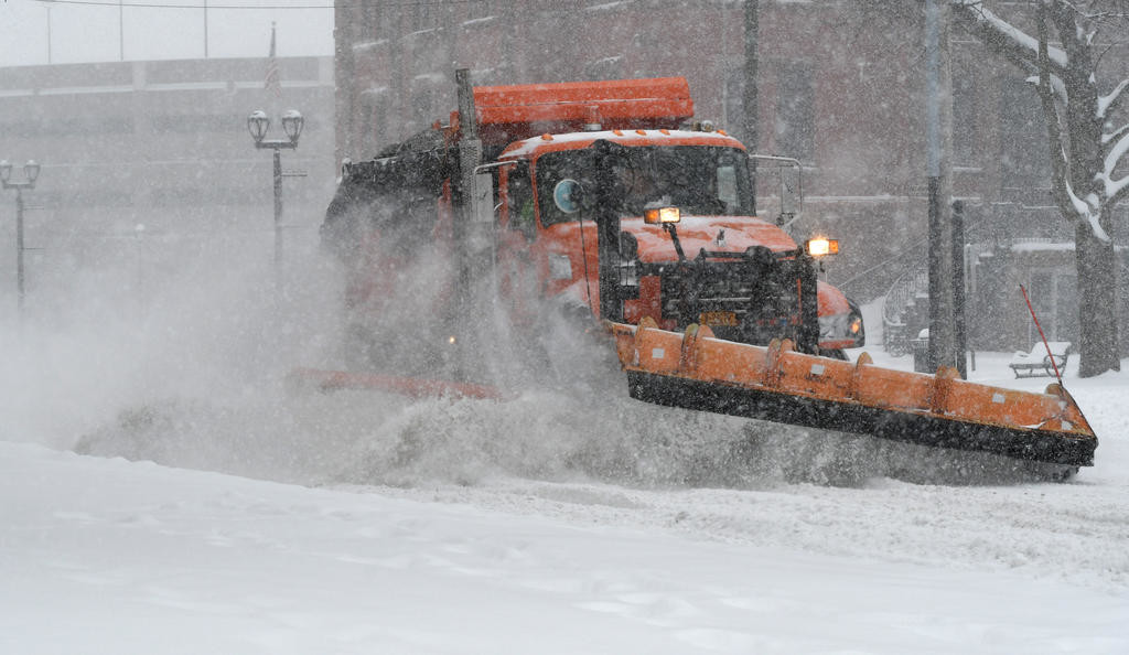 CLEARING A PATH — A city snow plow rattles along North James Street on Tuesday afternoon.  Plows were out constantly yesterday and overnight trying to clear streets of nearly two feet of snow.
 (Sentinel photo by John Clifford)