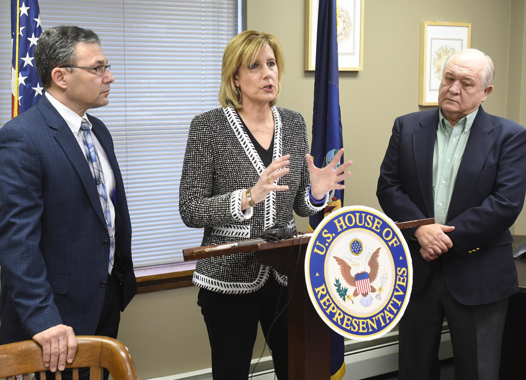 SEEKING AMENDMENT — Rep. Claudia Tenney, R-22, speaks during a press conference at her office in New Hartford today in support of the Medicaid Local Share Limitation Amendment, which she said would relieve upstate New York counties from a property tax mandate passed down by the state government. Joining Tenney are Vince Bono, left, vice chairman of Herkimer County Legislature and Herkimer County lawmaker Bernard Peplinski Sr.
 (Sentinel photo by John Clifford)