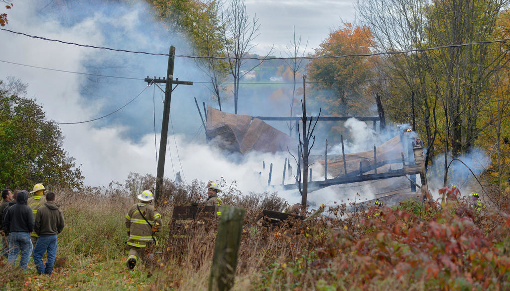 TOTAL LOSS — Firefighters look over the smokey remains of an old farmhouse on Wynn Road in Trenton Friday morning. Fire officials said the fire was a quick knockdown, and the cause remains under investigation. Story on page 3.
 (Sentinel photo by John Clifford)