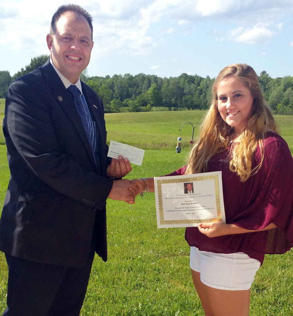 CONGRATULATIONS — Verona Town Councilman Fred Scherz Jr. hands a certificate of accomplishment and a check for $250 to Vernon-Verona-Sherill student Kierstyn Kahler. Kahler won the 7th annual Fred Scherz Memorial Scholarship for Volunteer Community Service.
 (Photo submitted)