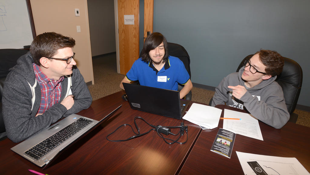 TRYING FOR ANOTHER WIN — Westmoreland high school seniors Stephen Cosco and Matthew Calogero work on privacy and security programming topics this morning with Westmoreland math teacher Nick Darrah, at left, during the annual Challenge Competition event at the Griffiss Institute. The two students were the winners last year. An awards ceremony for this year’s competition will be held Friday.
 (Sentinel photo by John Clifford)