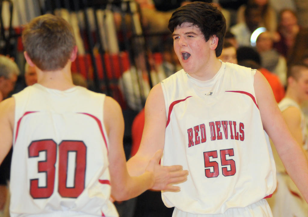 PUMPED UP — Vernon-Verona Sherrill’s Rylin Turley, 30, and Dewey Roden, 55, celebrate coming off the court during Tuesday’s non-league game in Verona. The Red Devils won an overtime thriller 64-61.
 (Sentinel photo by Makenzi Enos)
