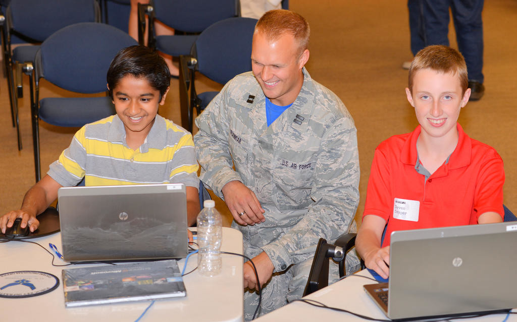 SPECIAL SCREENING — Harshil Thaker, left, of Utica and Deven Draper, right, of Deerfield, work with Air Force Capt. Trevor Vranicar during a Cyber Camp 2.0 activity Friday at the Griffiss Institute. The camp, which was from Monday through Friday, is an Air Force Research Laboratory STEM (science, technology, engineering, math) outreach program with an objective that was to prepare students to remotely defend a website that was under attack. The camp was geared for grades 8-12.The institute will host four other STEM-related camps this summer.
 (Sentinel photo by John Clifford