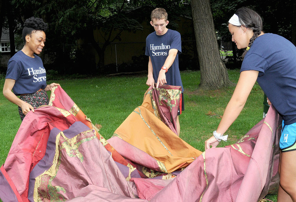 GETTING READY TO PITCH — From left, Hamilton College freshmen Chidera Onyeoziri of Brockton, Mass., Case Tatro of Titusville, Fla., and Emma Raynor of Rockville, Md. get started setting up a tent this morning at the Rome Art and Community Center for the upcoming Renaissance Revels event. They were part of the annual Hamilton Serves day of service in which freshmen at the college volunteered at about 56 non-profit organizations in the Mohawk Valley.