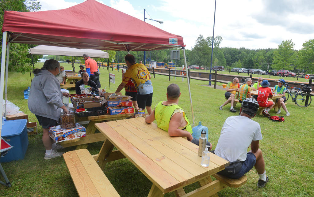 SNACK BREAK — Bicyclists participating in Cycling the Erie Canal stop for snacks at Lock 21 in New London on their way to Rome Thursday, where they spent the night on the grounds of Fort Stanwix National Monument. They departed this morning for Herkimer County.