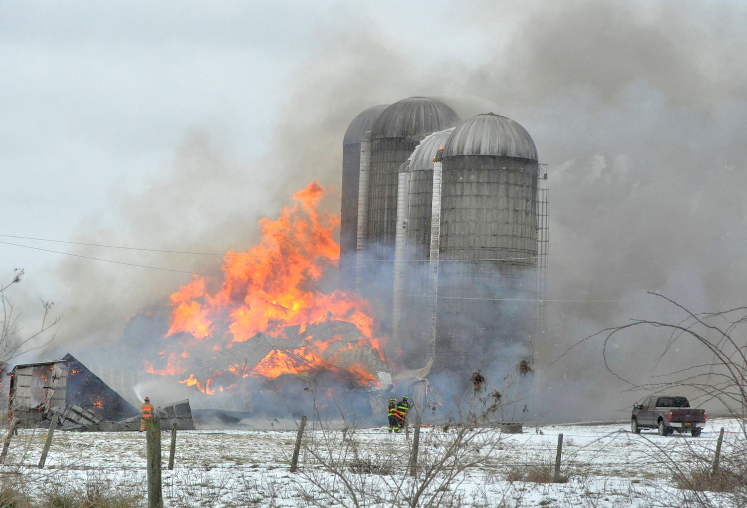 FULLY INVOLVED — Bright orange flames leap into the sky during a large barn fire on Whittaker Road in Trenton on Sunday. Fire officials said the 60-foot by 200-foot barn was fully involved, and had partially collapsed, by the time they arrived on the scene.