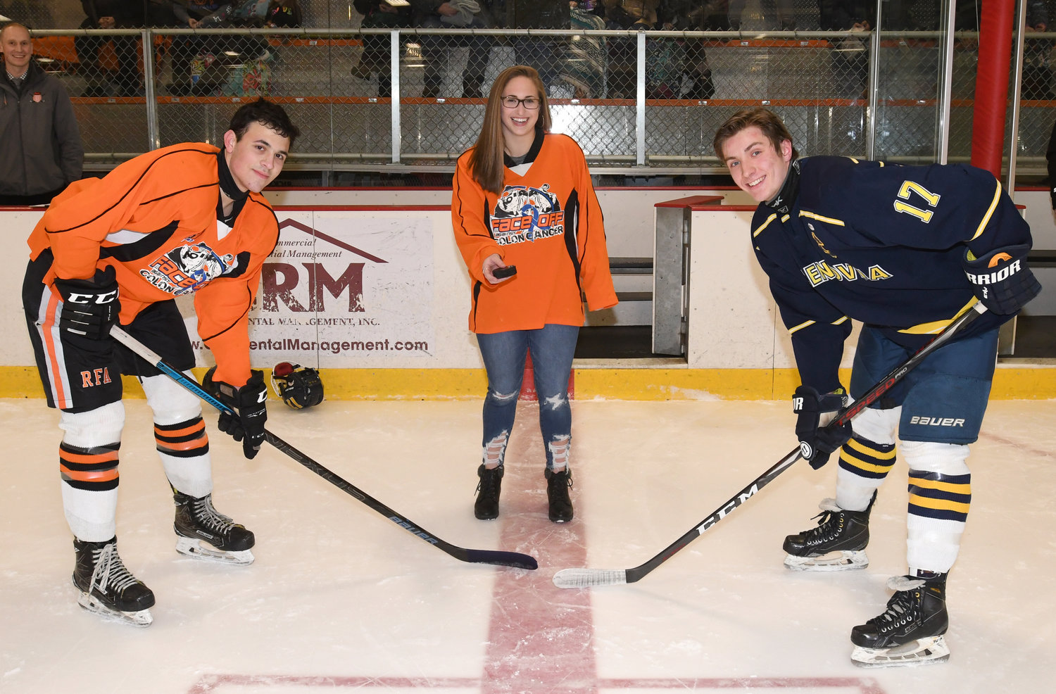 FACE OFF — The ceremonial puck drop at Friday night's Face Off Against Colon Cancer benefit game at Kennedy Arena was made by Kaitlyn Mastracco, daughter of former Rome Free Academy coach and player Peter Mastracco, who died of colon cancer. At left is RFA captain Danny Mecca and at right is Cazenovia captain Dominic Paglia. Over $1,000 was raised during the game.