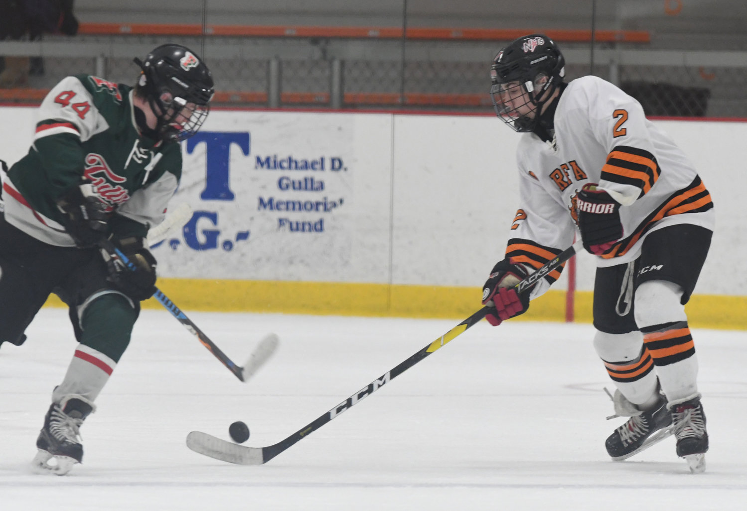 THREE-POINT NIGHT — Rome Free Academy’s Jake Hall, right, and Fulton’s Derek Schumaker battle for control of the puck Friday night at Kennedy Arena. The Black Knights won, 4-1, with Hall assisting on three of the goals.