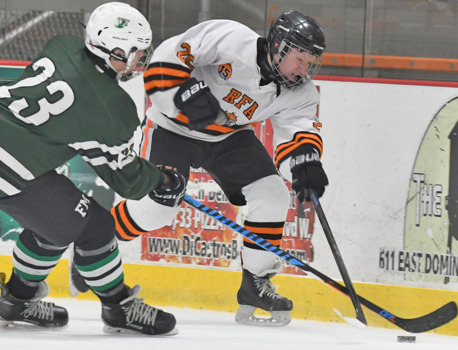 GET POSSESSION — Eli Dormio of Rome Free Academy, right, and Fayetteville-Manlius’ Jason Tedeschi go after the puck on Tuesday night at Kennedy Arena. F-M won 2-1, ending Rome’s nine-game home winning streak.