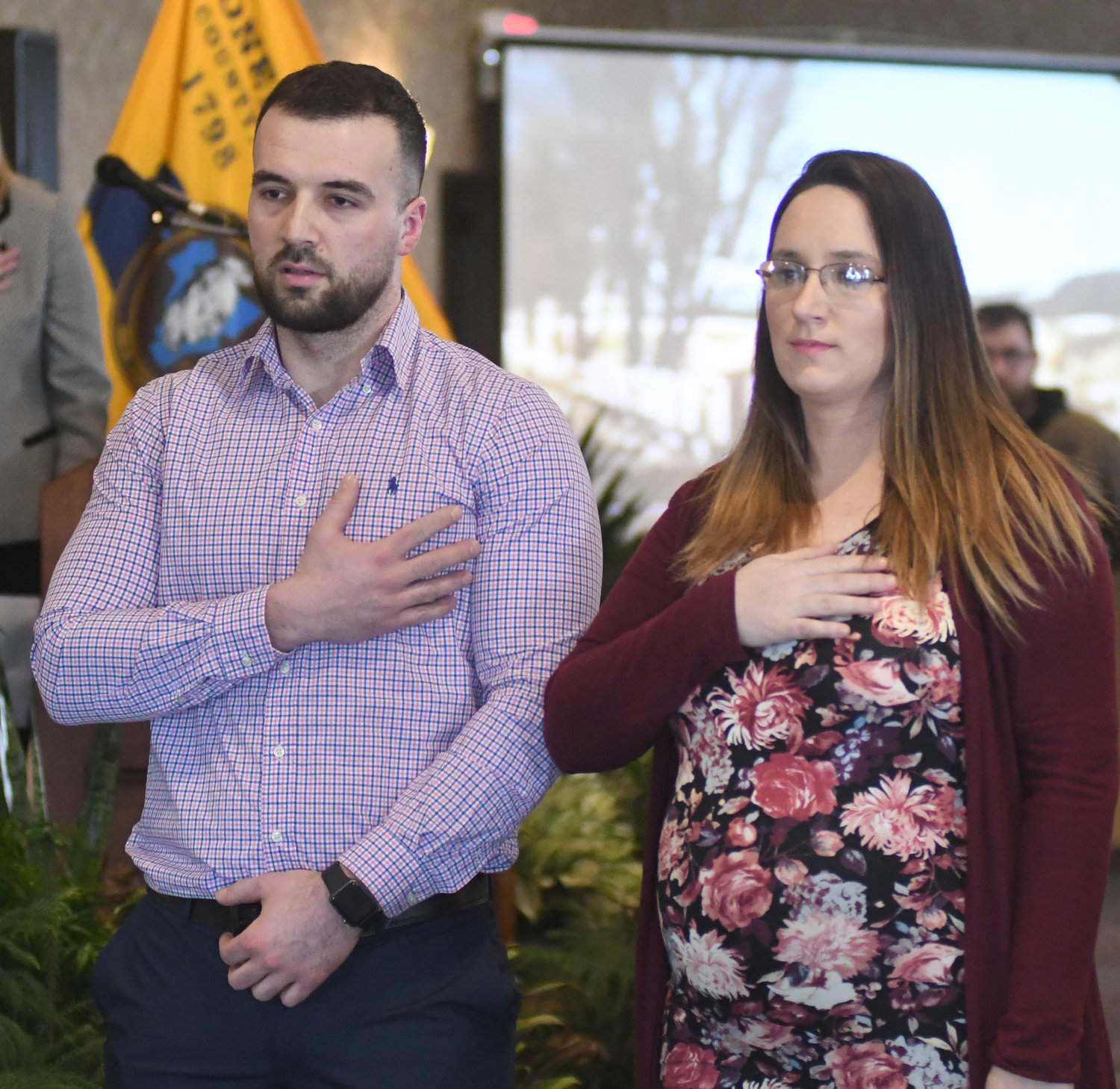 LEADING THE PLEDGE — Edin and Mahira Patkovic lead the Pledge of Allegiance at the start of Tuesday’s State of the County speech. During his speech, Oneida County Executive Anthony J. Picente Jr. discussed the Patkovics and used their story to highlight the need for services for refugees, including English lessons for non-native speakers.