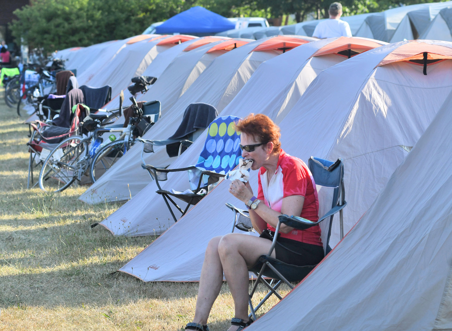 PIT STOP — Enolla Nelson from Raleigh, N.C., enjoys ice cream after a hot day on her bike, as riders during the 2018 Cycle the Erie Canal Bike Tour spent a night in Rome. More than 700 riders are expected to camp out on the Fort Stanwix lawn in this year’s event on Thursday.