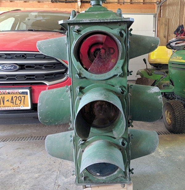 NEWEST EDITION — This 1920s to 30s Crouse Hinds porthole signal rests in the garage of Tony Taurisano’s Westmoreland home as it receives some repairs. The collector just purchased the street light in May.