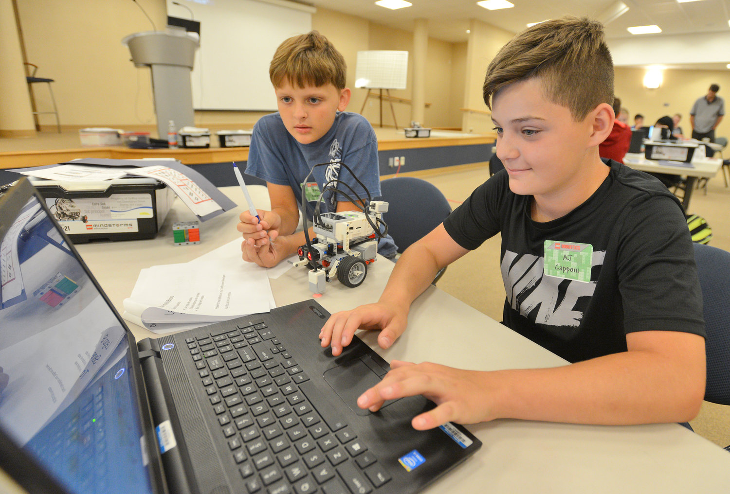 SETTING UP THEIR ROBOT — Clinton Elementary School students Jason Leonard and AJ Capponi work on programming their Lego robot at a STEM Outreach Program camp Wednesday at Griffiss Institute.