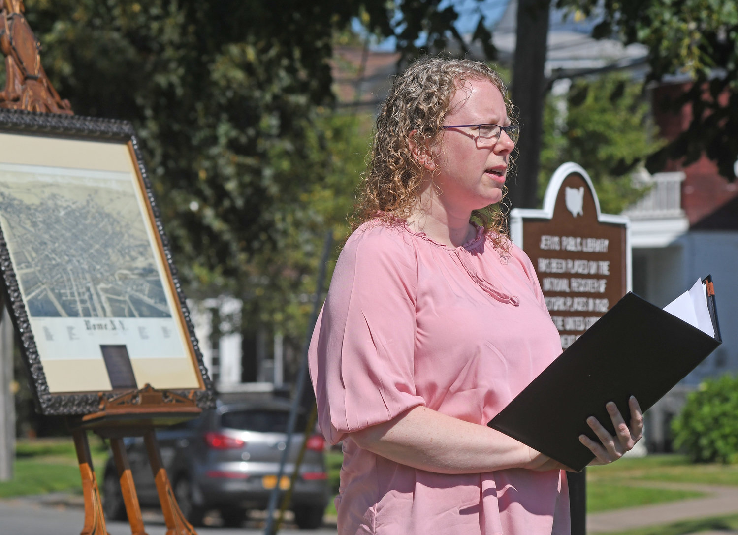 TIME TO SHINE — Lisa Matte, executive director of Jervis Public Library, discusses famed Rome engineer John B. Jervis during a ceremony on Tuesday in the bright sunshine on the library's front lawn.