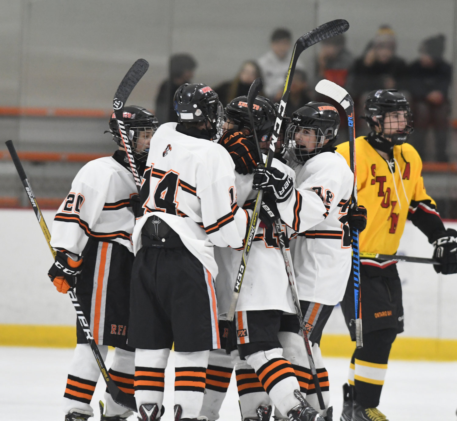 FIRST OF EIGHT — Rome Free Academy players celebrate their first goal of the game against Ontario Bay on Tuesday night at Kennedy Arena. From left are Derek Millington, Tyler Davis, goal scorer Jared Hussey and Sam Wilson. RFA went on to an 8-1 win.
