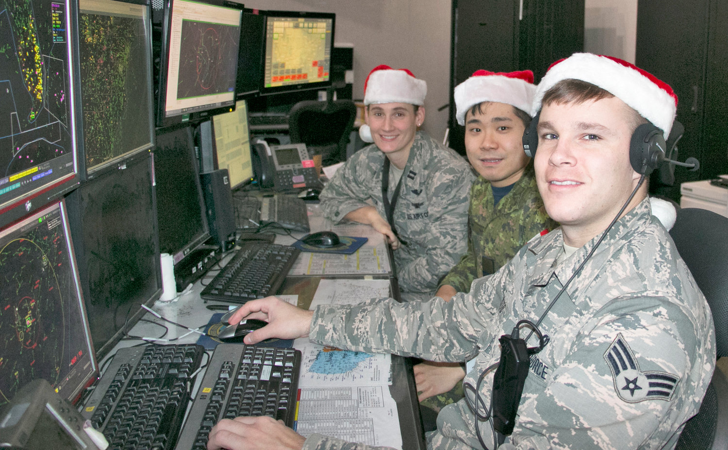 ON THE SANTA WATCH — Airmen at the Eastern Air Defense Sector recently conductedtraining in preparation for tracking Santa’s Christmas Eve flight. From front to back: Senior Airman Timothy Destito, New York Air National Guard; Capt. John Byeon, Royal Canadian Air Force, and Capt. Sarah Atherton, New York Air National Guard. Capt. Atherton and Senior Airman Destito are members of the 224th Air Defense Squadron while Capt. Byeon is a member of the Canadian detachment at EADS. For more information on NORAD’s Christmas Eve Santa tracking operations, visit noradsanta.org.