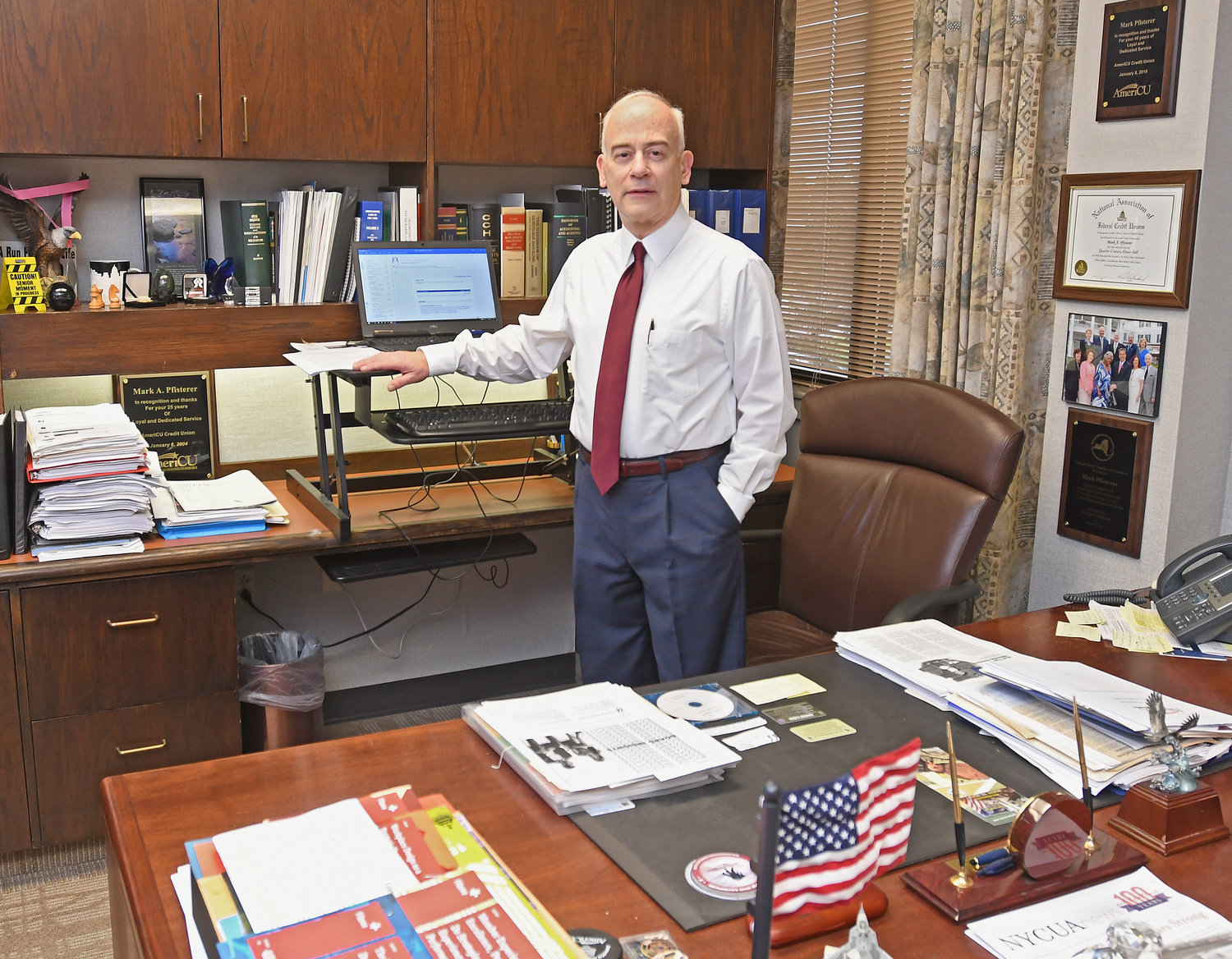 LOOKING FORWARD — Mark Pfisterer in his office after 42 years at AmeriCU. At some point this year, Pfisterer said he will officially retire and hand off the reins to a successor that is currently being sought.