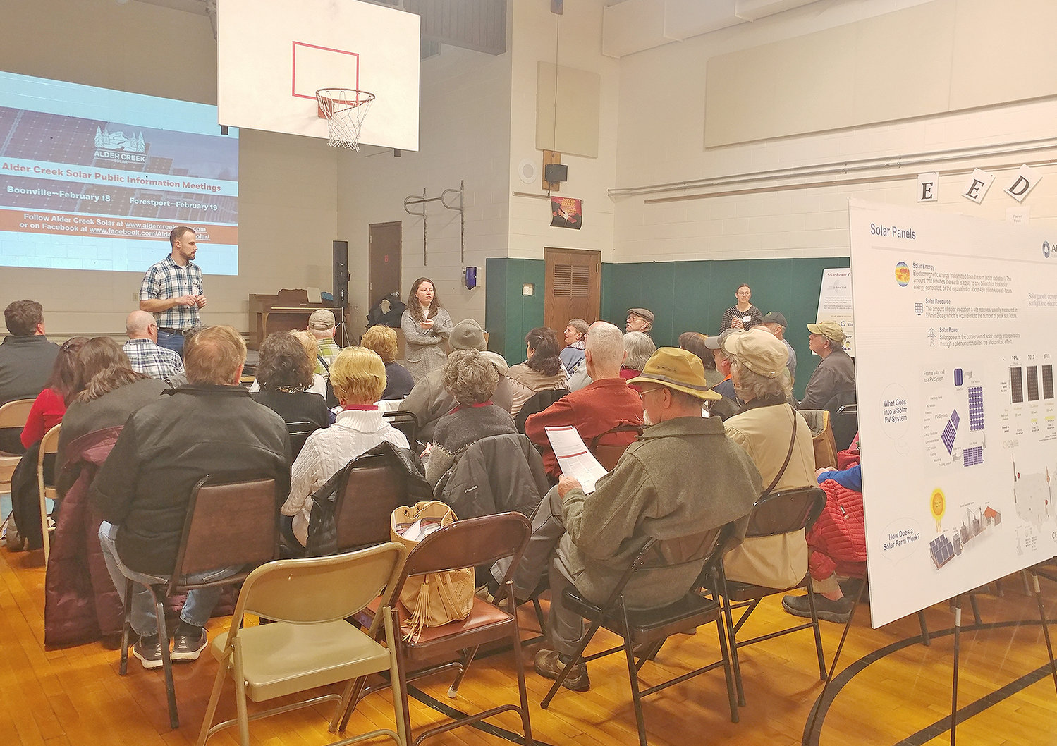 SOLAR MEETING — Representatives of Apex Clean Energy speak during a meeting at Boonville Elementary School Tuesday to share with residents plans for a proposed solar-power project near the Adirondack Beverage Company.
