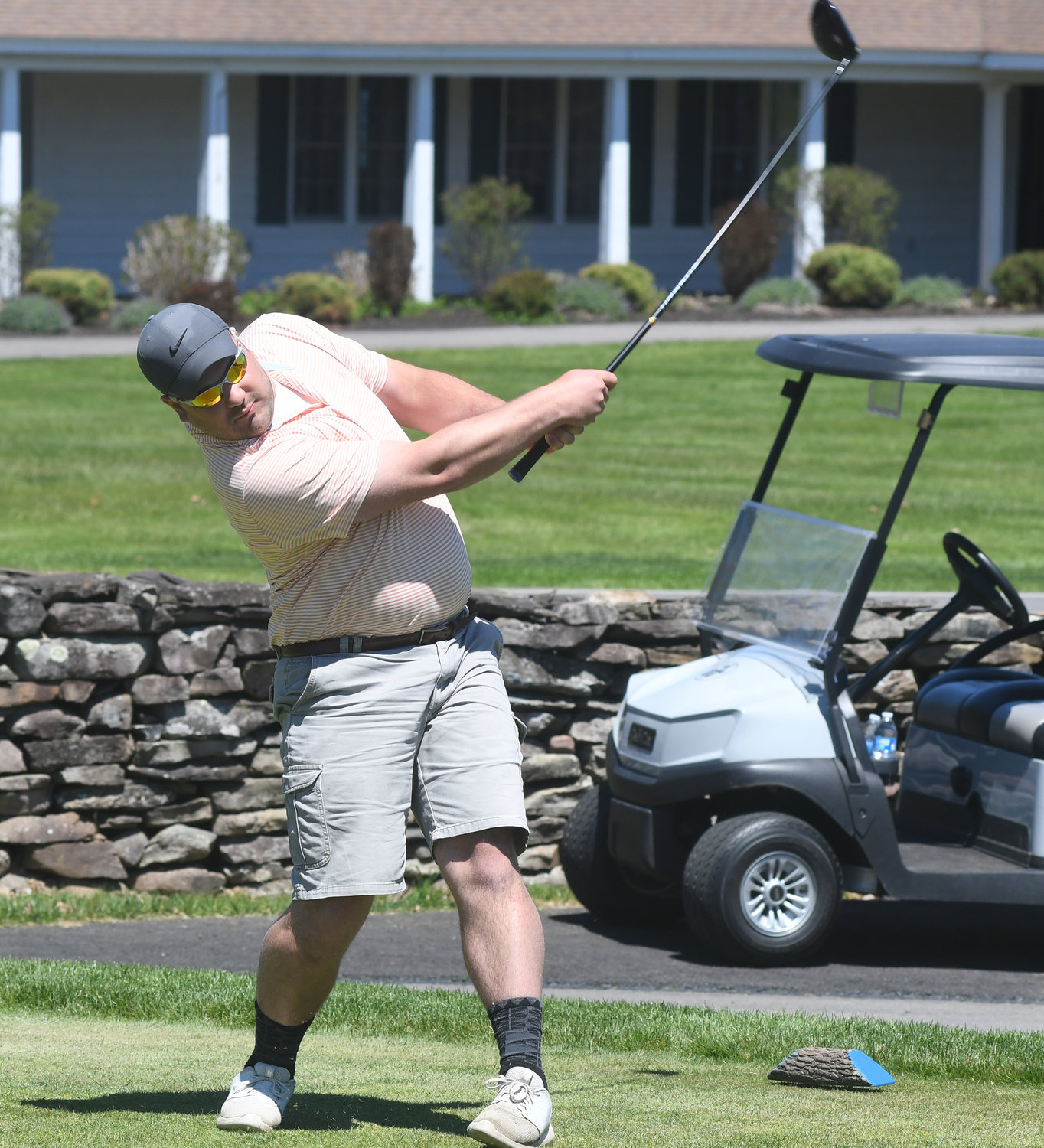 WATCHING IT GO — Sentinel sports writer Kenny Kudrewicz watches his drive on the first tee at Teugega Country Club Wednesday afternoon.