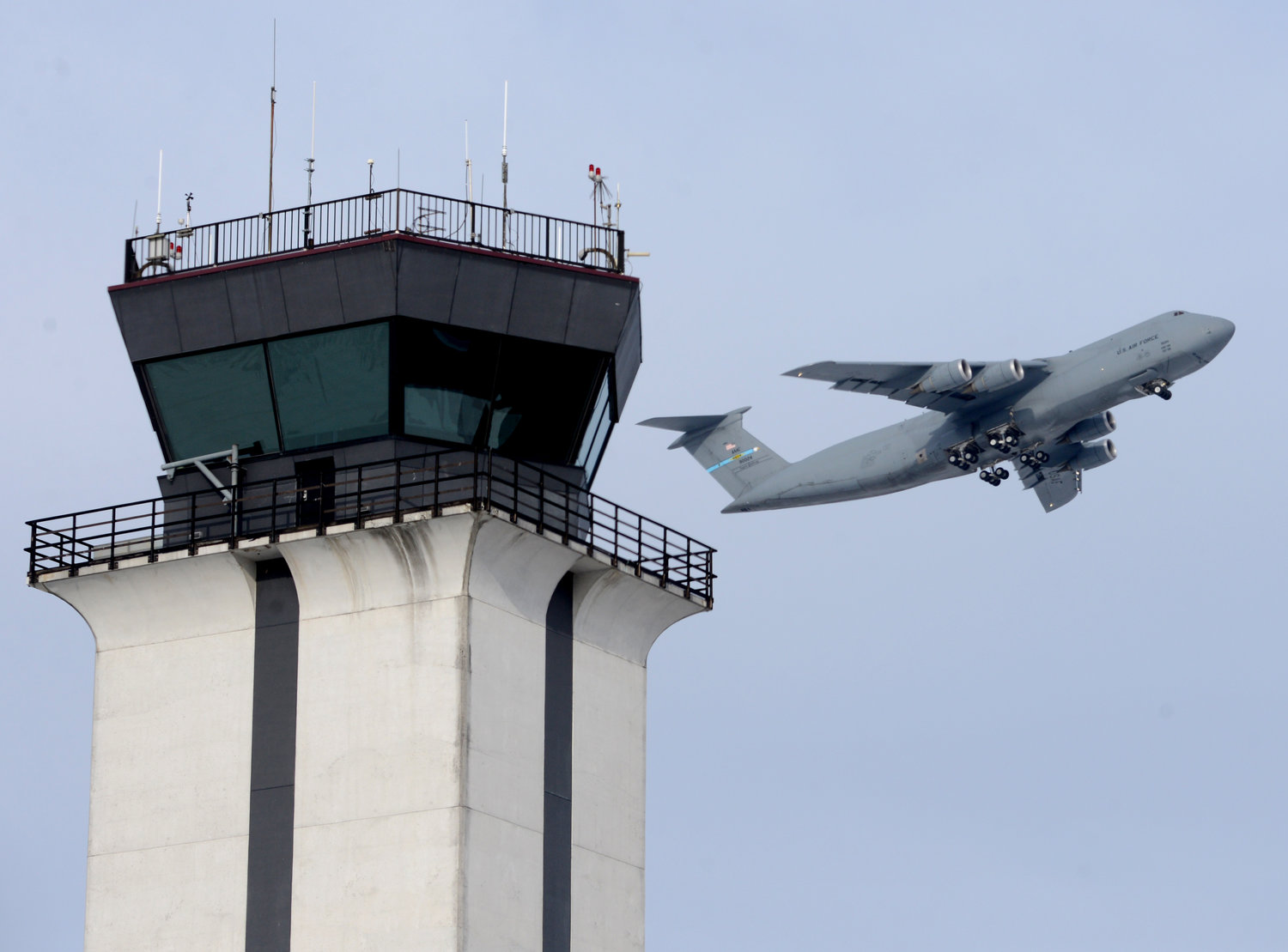 A departing C-5 from Dover lifts off with the Griffiss tower in the foreground.