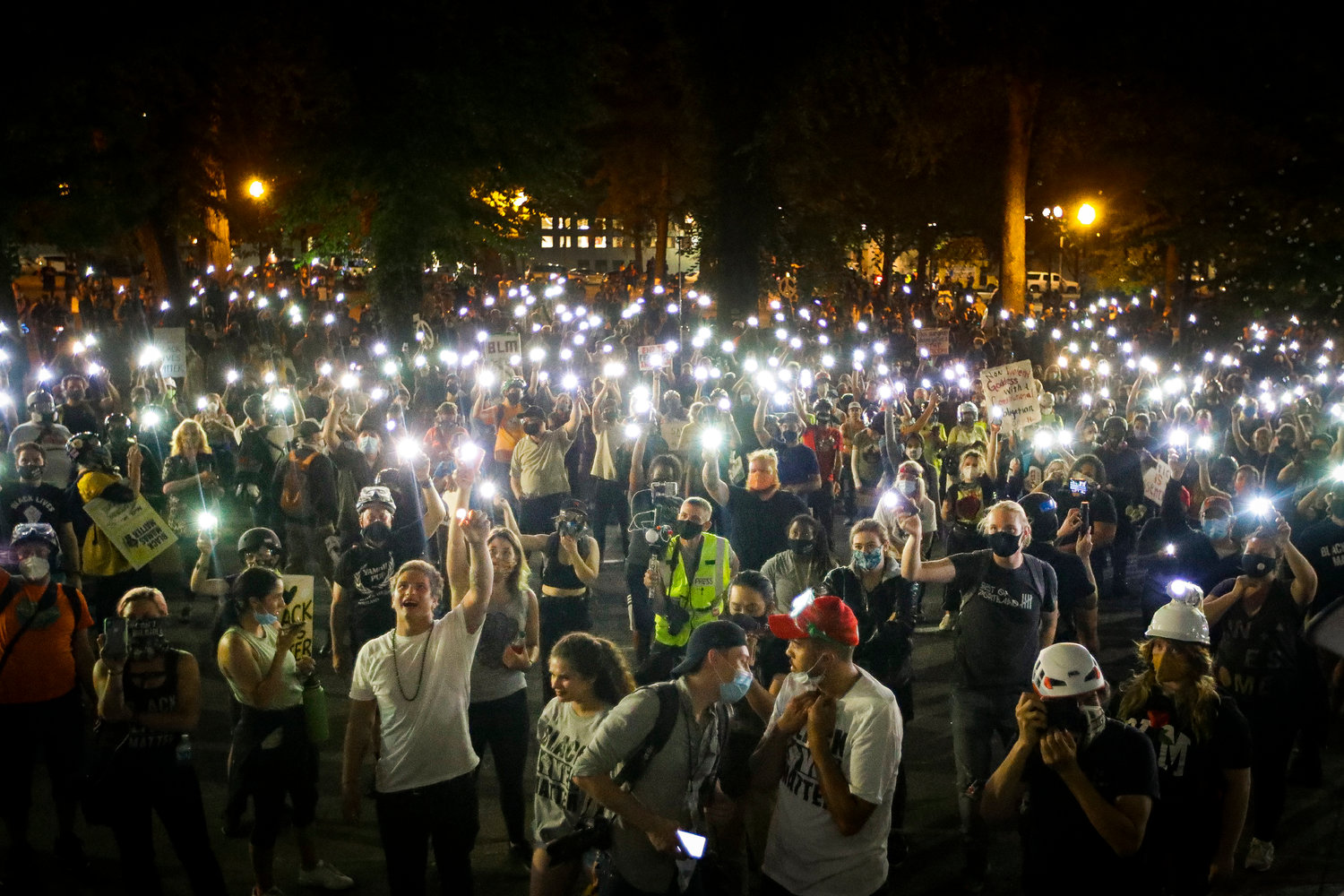 MINIATURE LIGHTS — Demonstrators raise their cell phone lights as they chant slogans during a Black Lives Matter protest at the Mark O. Hatfield United States Courthouse Wednesday in Portland, Ore.                  (AP Photo)