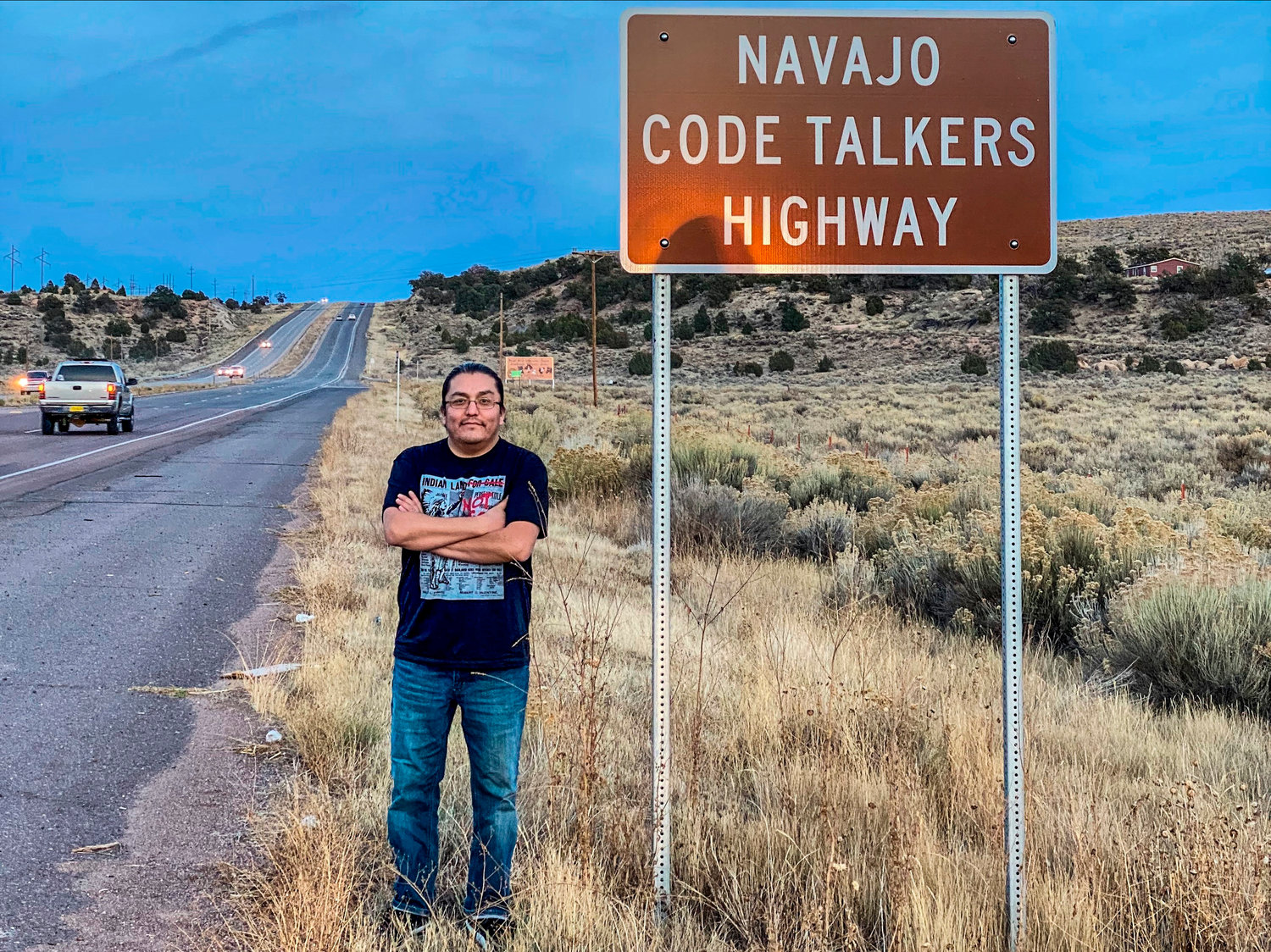 BETTER BREW — This photo courtesy of LT Goodluck shows Goodluck next to a road sign marking Highway 264 honoring his grandfather, Navajo Code Talker, John V. Goodluck near Window Rock, Ariz.  In honor of National Navajo Code Talkers Day, a Washington, D.C., craft brewery recently rereleased its Code Talker American Pale Ale.