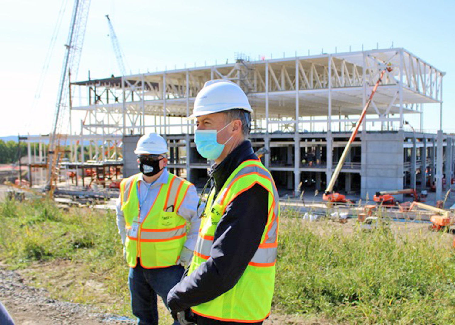 ON-SITE — Jeff Maidment, construction manager at Cree, and company president and CEO Gregg Lowe stand at the site of the Cree Inc. silicon carbide wafer factory under construction in Marcy on Friday. The billion-dollar fabrication facility is on schedule for occupancy this spring and production about a year later, the company says.