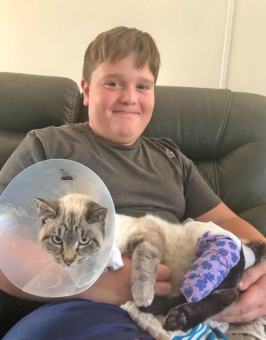 ON THE MEND — 11-year-old Jayden Rattray of Camden holds “Lucky”, a cat rescued after it was hit by a car in Camden and left for dead. After failing to find an owner, Jayden has adopted the cat as his own.