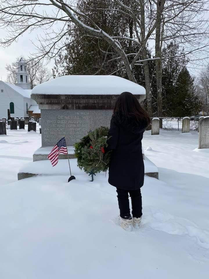 SNOWY SERVICE — Jeannine Olney, of the Fort Stanwix Chapter of the Daughters of the American Revolution,  places a wreath at Gen. William Floyd’s grave in the Westernville Cemetery on Saturday as part of the region’s Wreaths Across America observance to honor deceased veterans during the holidays. Before placing the wreath, the volunteer will say their name to ensure that the legacy of duty, service and sacrifice of that veteran is never forgotten. Volunteers also placed wreaths on veterans graves at St John’s Cemetery; St. Mary’s Cemetery; St Peter’s Cemetery; and Rome Cemetery and Wright Settlement Cemetery. (Photo courtesy Ella Alsheimer/FSDAR)