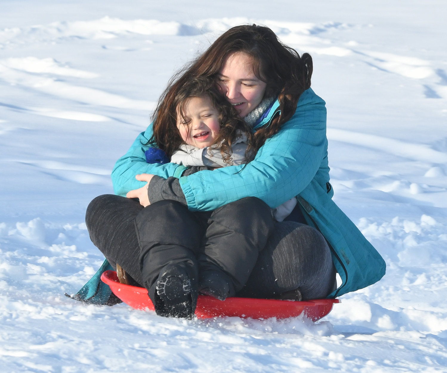 KEEPING WELL IN HAND —  Rochelle Snyder and her daughter Rylee Nolan, 3, slide down a hill at Lee Town Park on Monday afternoon.