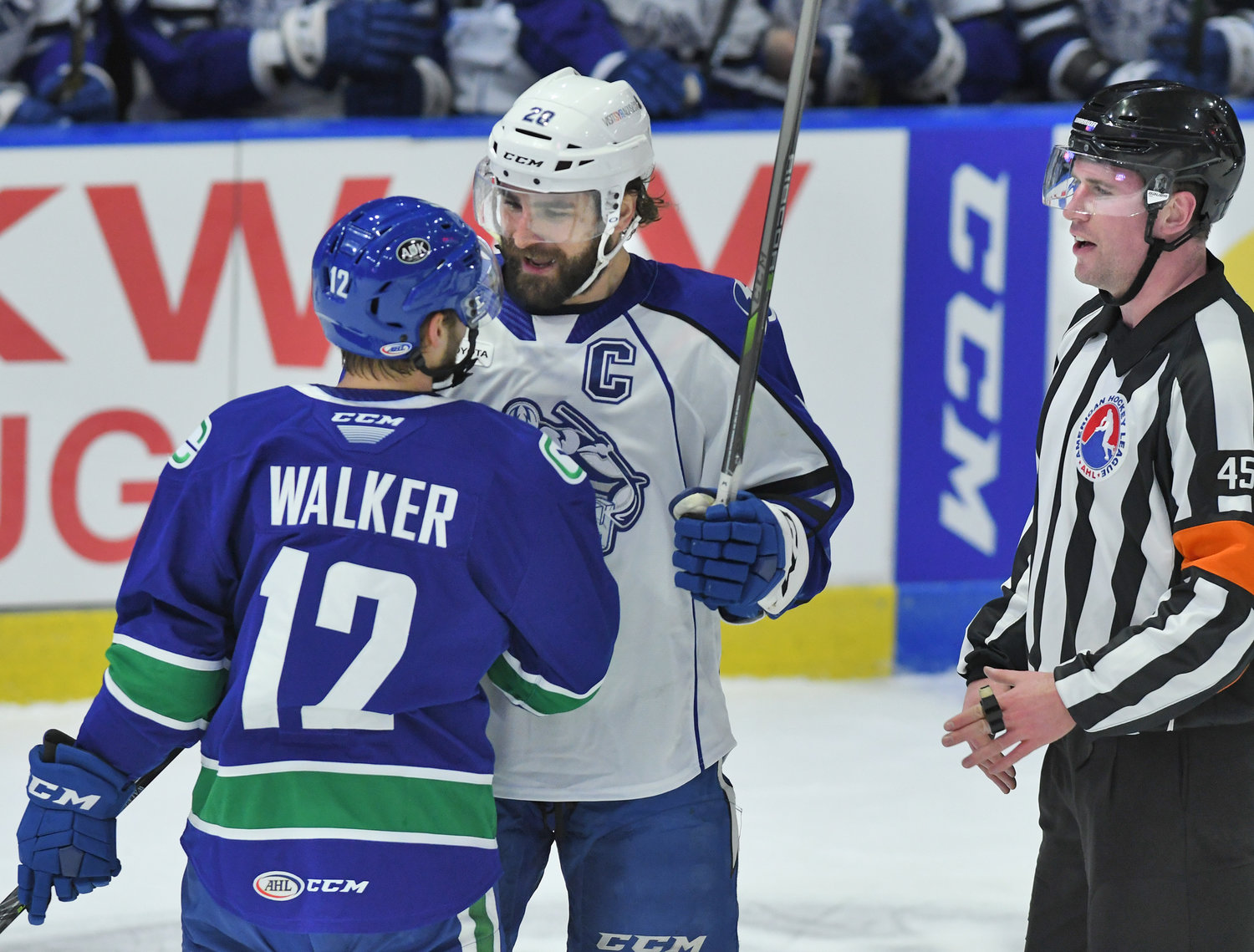 A LITTLE CHAT — Utica Comets’ Nathan Walker and Syracuse Crunch captain Ryan Lohin have a discussion during the first period of the Comets’ home opener Wednesday. Walker scored a power play goal in the second period to help Utica to a 5-2 victory.