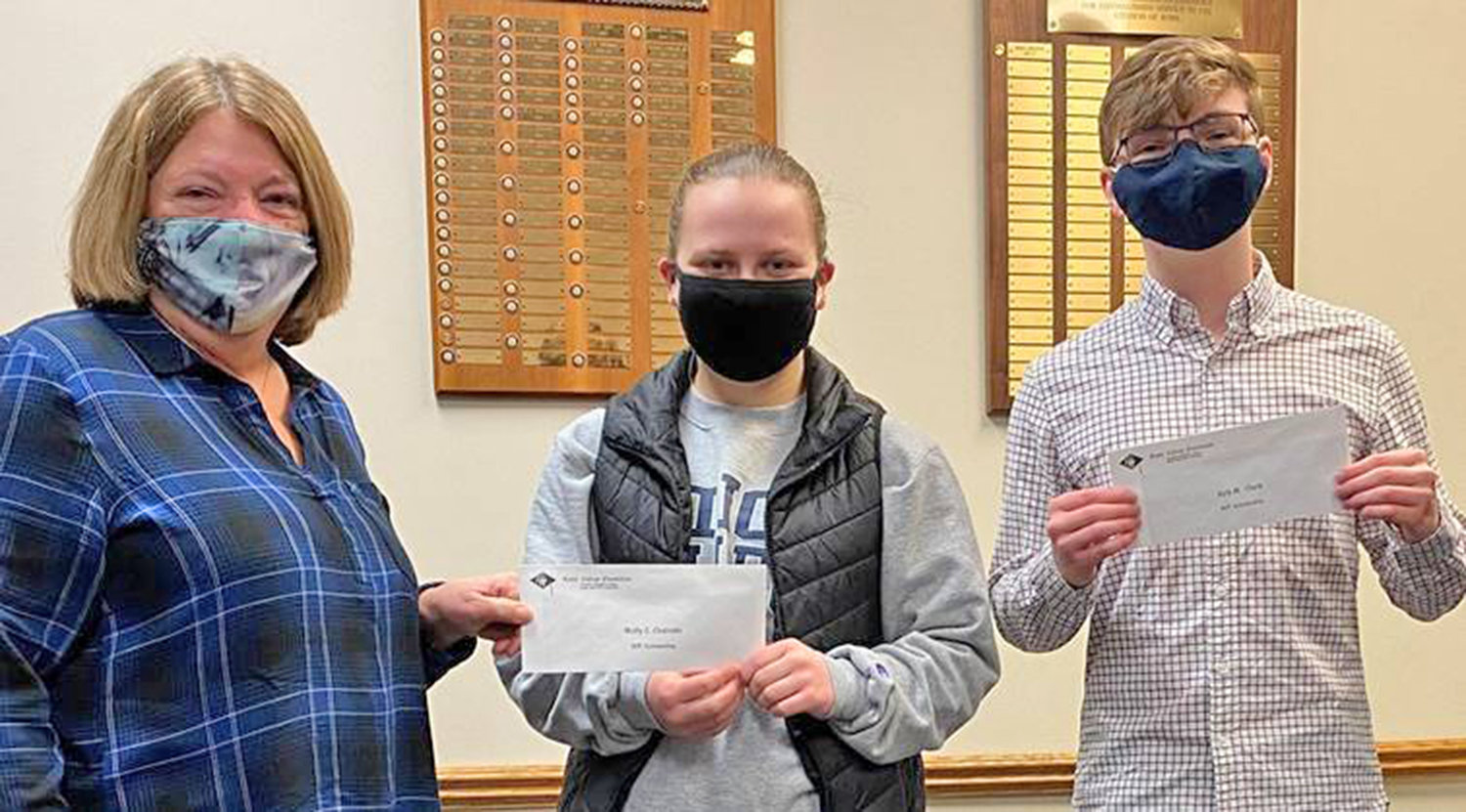 LOCAL SCHOLARS — Suzanne Carvelli, president of the Rome College  Foundation, presents a pair of organization scholarships to Molly Closinski, a Utica College student; and Kyle Clark, who attends the SUNY Polytechnic  Institute.