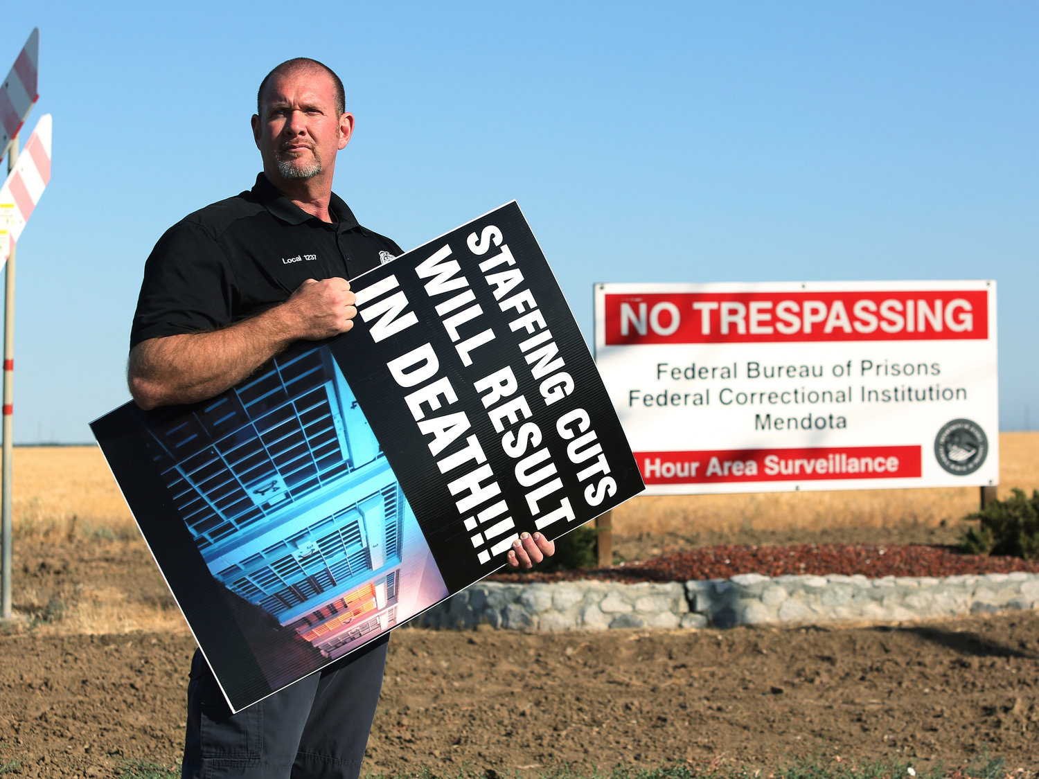 STAFF SHORTAGE — Aaron McGlothin, union president at the Federal Correctional Institution at Mendota, poses for a photo while leading a protest against staffing shortages, near the prison entrance in Mendota, Calif., Monday.    (AP)