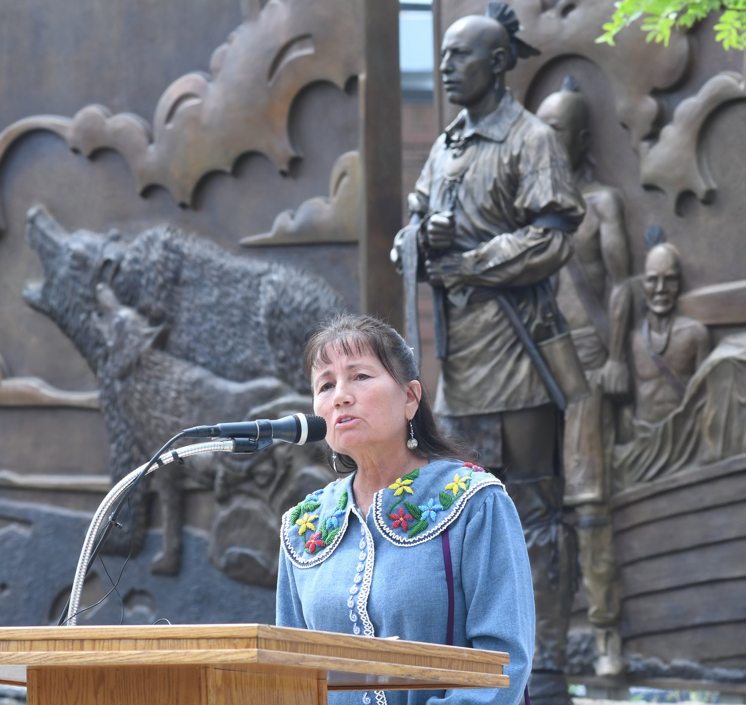 WORDS OF PEACE — Wolf Clan Representative Sheri Beglen, of the Oneida Nation Council, speaks the Oneida language as she offers Thanksgiving during the unveiling ceremony for the new bronze Oneida monument on West Dominick Street Tuesday, which was then translated.