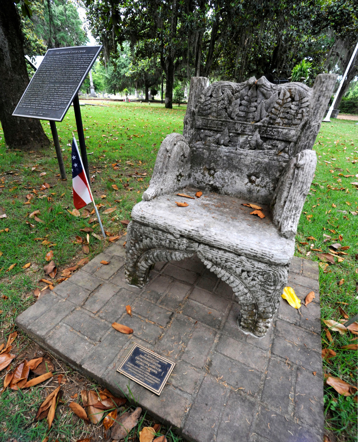 A monument to Confederate President Jefferson Davis, that was previously stolen, is shown back at its regular site at a cemetery in Selma, Ala., on Wednesday. Three people were charged following the disappearance of the chair, which was recovered in New Orleans and is now glued down.