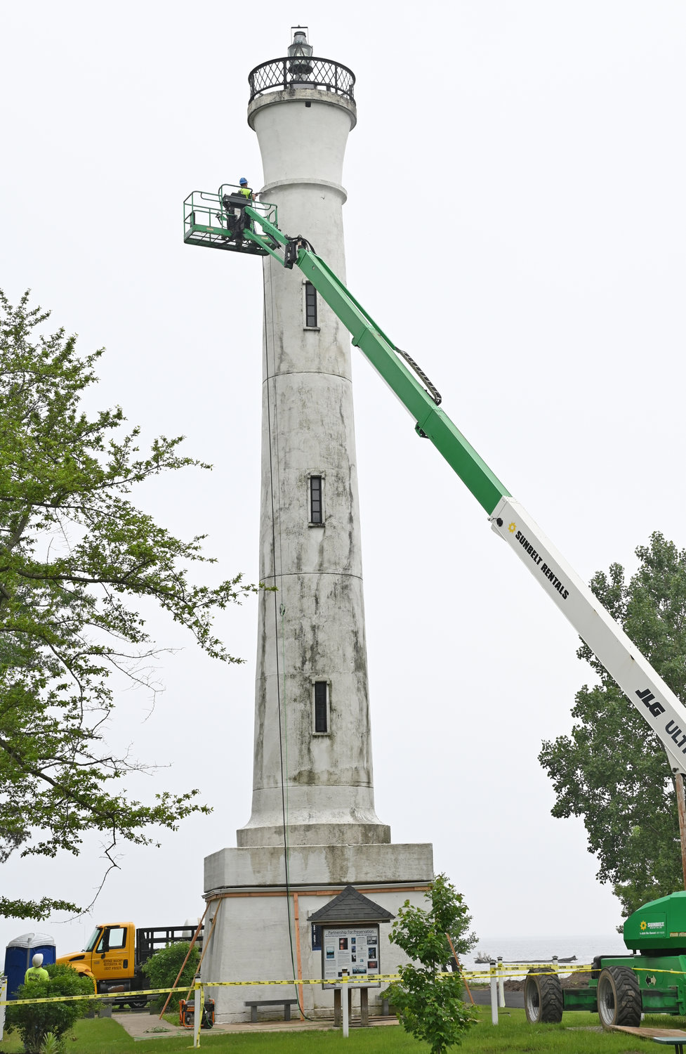 GETTING IN TIP-TOP SHAPE — New York Power Authority crews pressure wash the Verona Beach Lighthouse on Wednesday afternoon as preparations are under way for the installation of LED lights as part of the Canal Corporation’s Iconic Lighting Project. The project will help to shine a spotlight on the historic structure and its place along the Erie Canal and Oneida Lake.