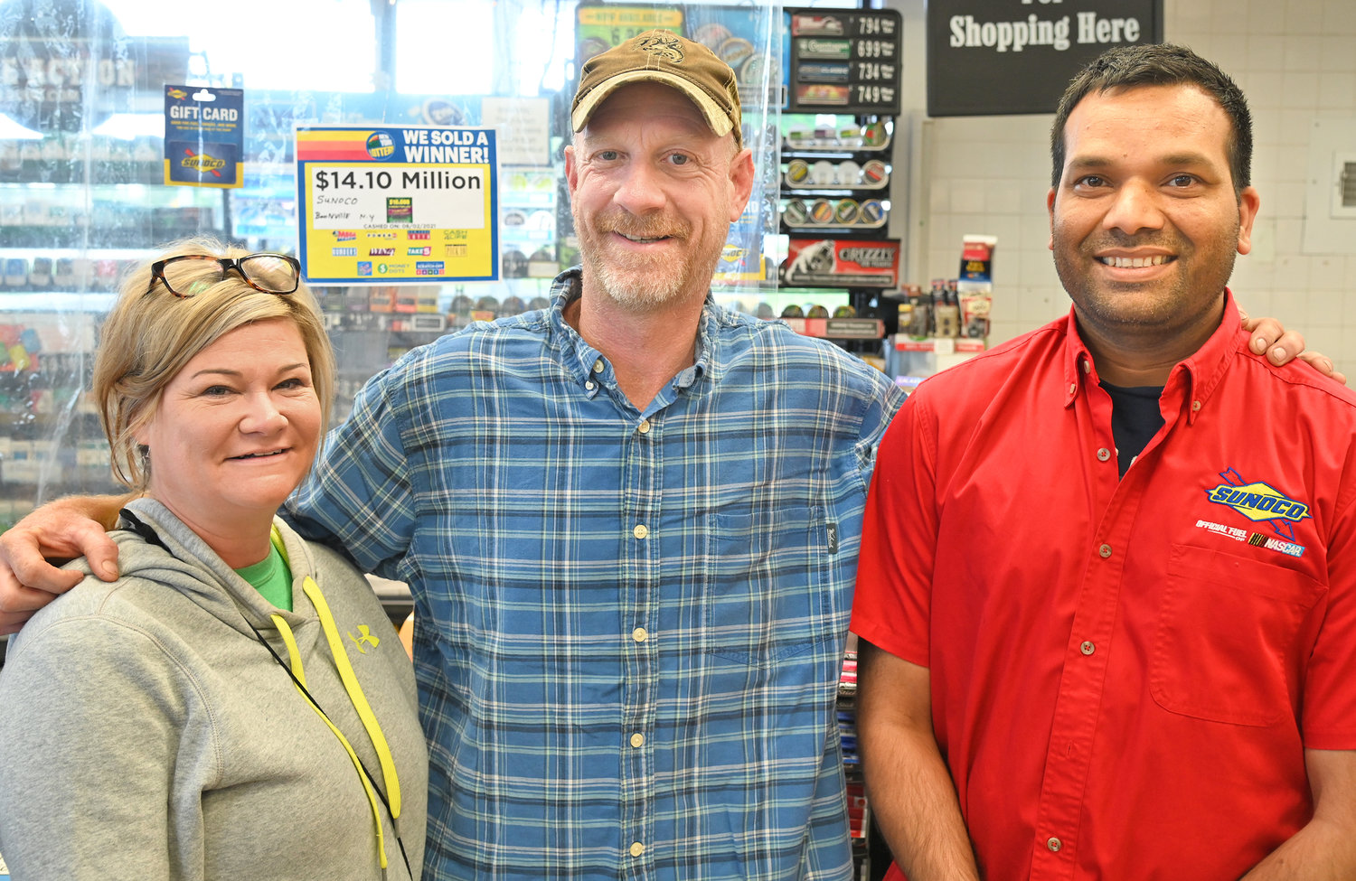 BIG WINNER — David Signor, middle, the winner of a $14 million lottery ticket is pictured with his girlfriend MacKenzie Earl, left, and Karam Singh, one of the store owners of the Boonville Sunoco.