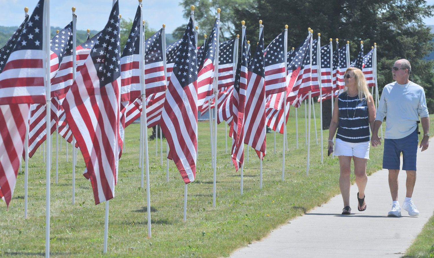 ENJOYING THE PATRIOTIC SIGHT — Joan O’Brien and her husband, Eddie, both of Florida, admire the flag display on Griffiss Park on Saturday.