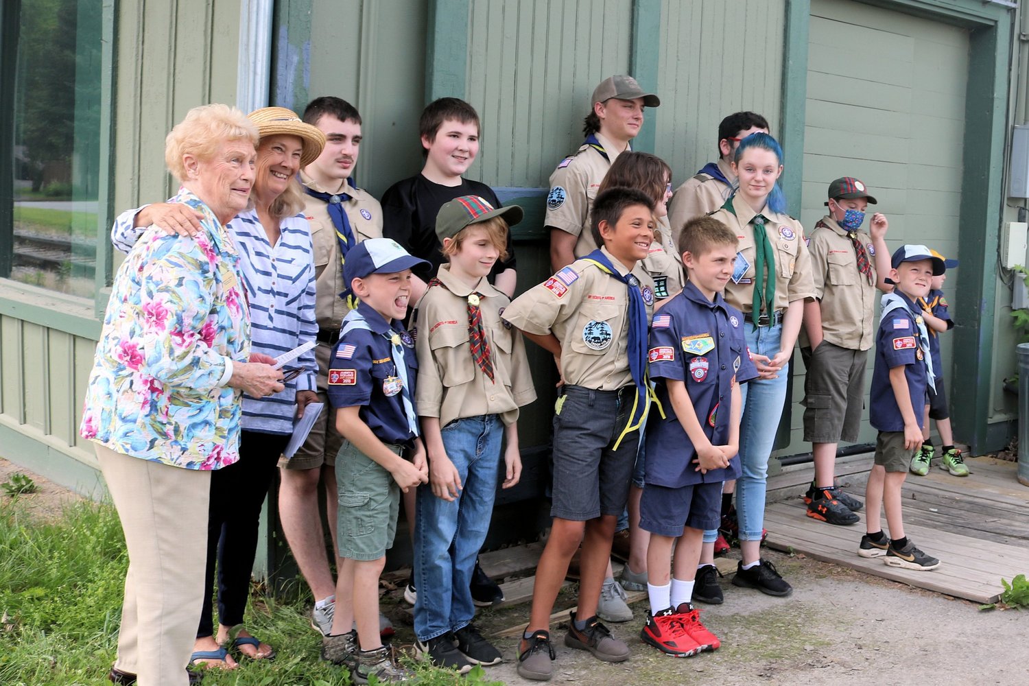 PATRIOTIC EFFORT — Holland Patent NSDAR Regent Beverly Seifried and Vice Regent Kitty Squire pose with a group of local Scouts who helped dispose of flags as part of a flag retirement ritual. The chapter and volunteers properly disposed of 2,447 flags.