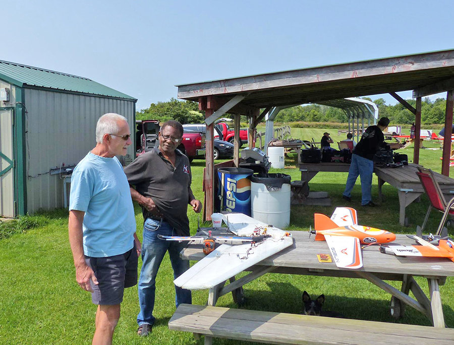 UNDER CONSTRUCTION — Members of the Academy of Model Aeronautics look over some parts of a radio controlled flyer.  The group is planning a Fun Fly event for Saturday, Aug. 7.