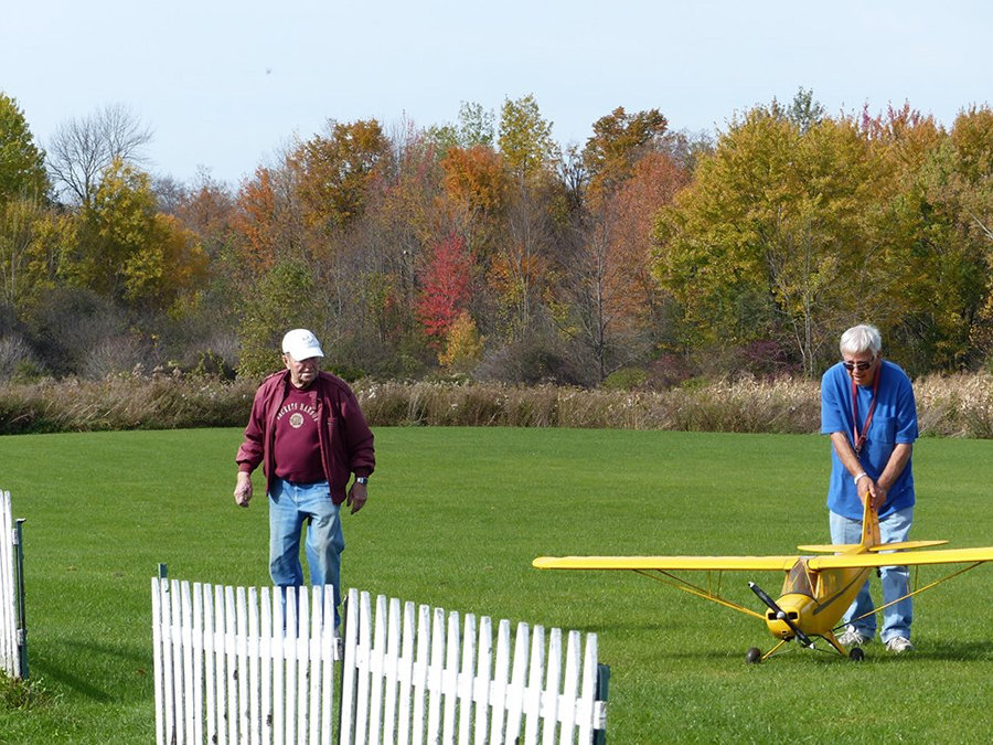 READY FOR TAKE-OFF — Members of the Academy of Model Aeronautics prepare a radio controlled flyer to take off.  The academy is planning its annual Fun Fly event to take place Saturday, Aug. 7, at Paradise R.C. Field at 6361 Route 5 in Westmoreland.