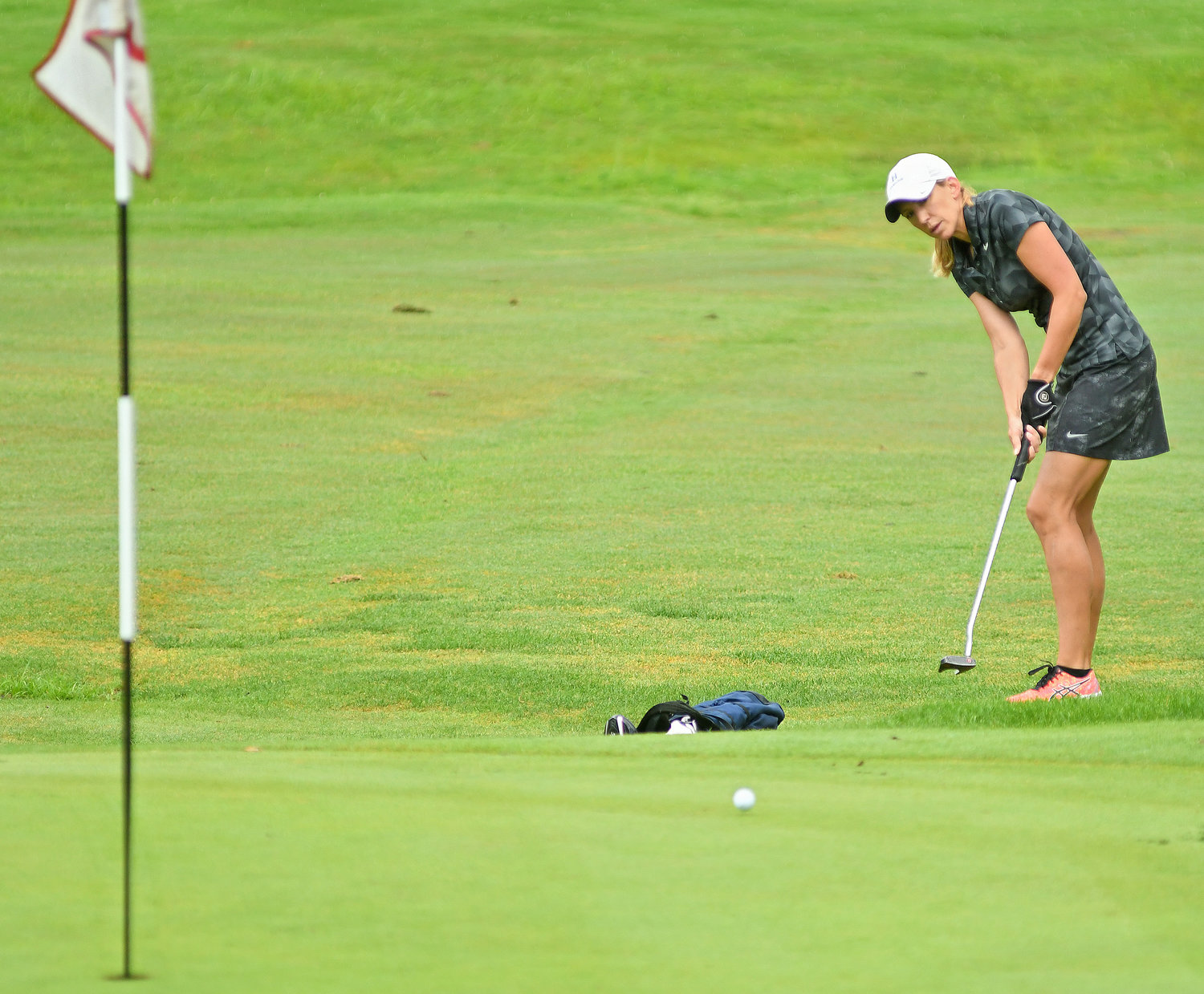 WATCHING THE PUTT — Rome's Lauren Cupp putts up to the fifth green during the second round of the Thirsty Owl New York Speedgolf Open on Monday at Rome Country Club. On Sunday at Teugega Country Club, Cupp set a new Women's Speedgolf World Record of 122:48, breaking the old one of 126:41. She shot a 72 and ran a time of 50:48 at Teugega.