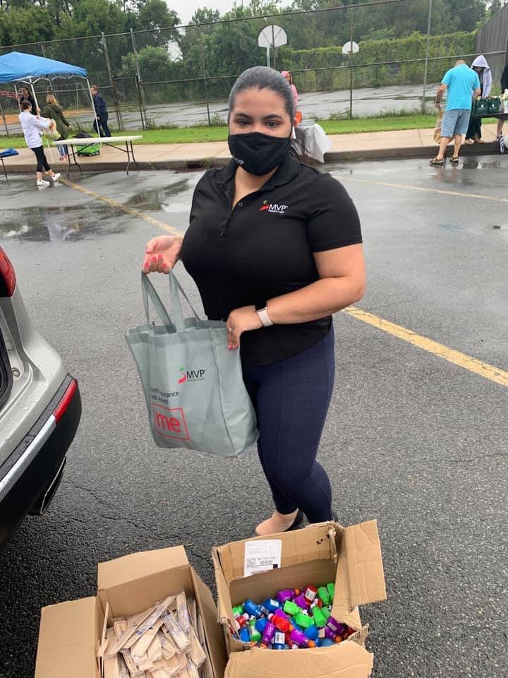 MVP — A volunteer with MVP Healthcare puts a bag of supplies in the trunk of a car during the Connected Community School’s Pack Your Pantry event on Tuesday.